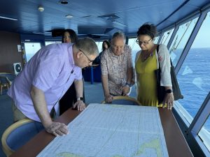 Marsh looking at nautical maps.