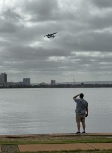 Marshall looking at Seaplane that just took off from the Swan River.