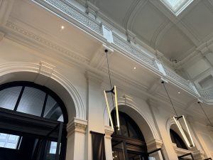 Modern lights against the beautiful old millwork.