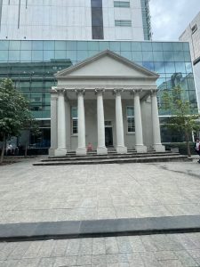 The last remaining millwork of the original Justice Building, in front of the new Justice Building.