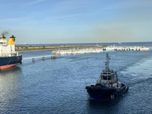 The tug boat, ready to help, if needed. More fishing boats in background.