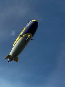 Blimp flying over Santa Monica Pier on foggy California afternoon
