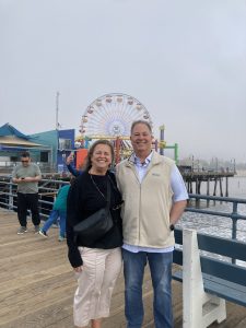 Sharon and Marshall Magee smiling on a cloudy day on Santa Monica Pier